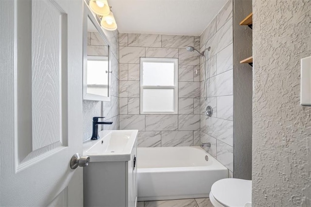 full bathroom with vanity, toilet, and tiled shower / bath combo