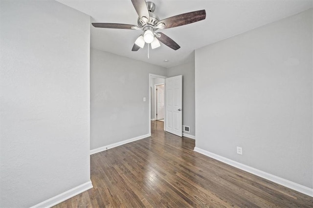 spare room with ceiling fan and dark hardwood / wood-style flooring