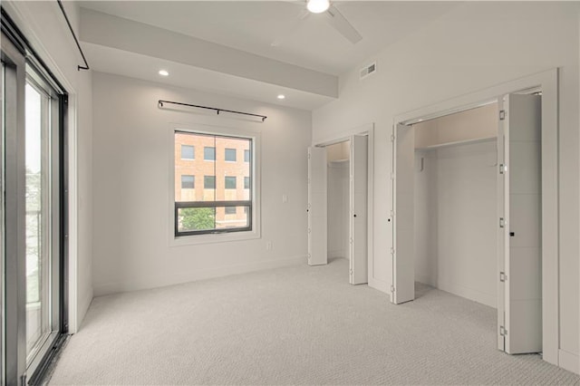 unfurnished bedroom featuring ceiling fan and light carpet