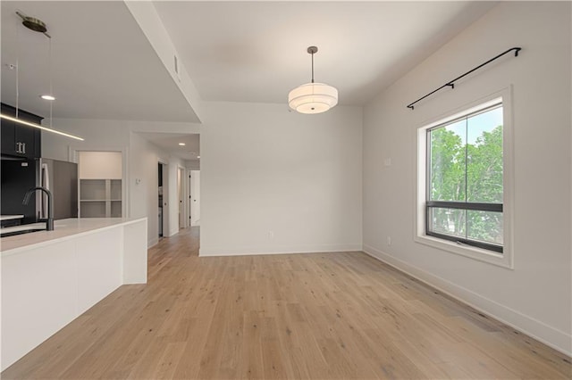 interior space with sink and light hardwood / wood-style flooring