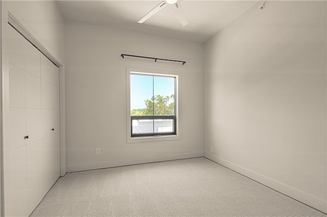 unfurnished bedroom featuring ceiling fan, a closet, and carpet