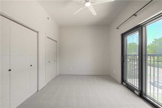 unfurnished bedroom with ceiling fan, access to exterior, light carpet, and a closet