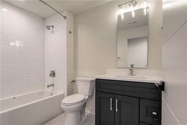 full bathroom featuring toilet, vanity, tile patterned floors, and tiled shower / bath