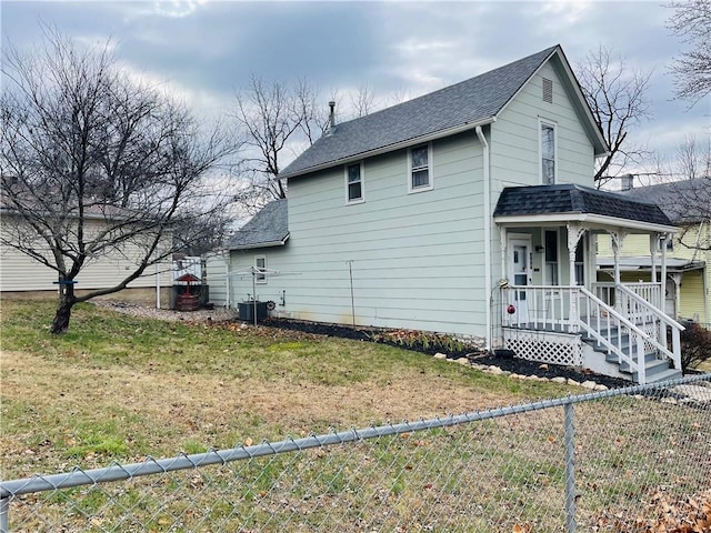 view of home's exterior featuring a yard, covered porch, and central AC unit