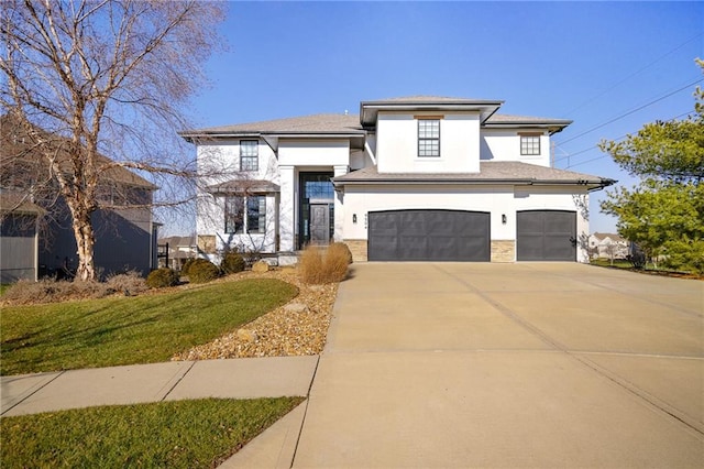 view of front of property featuring a garage, driveway, stone siding, stucco siding, and a front yard