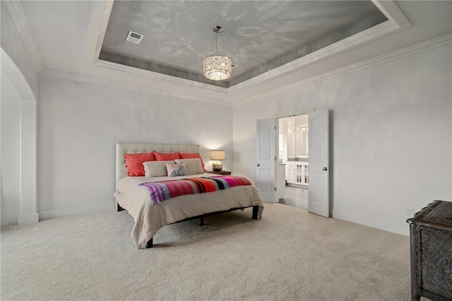 carpeted bedroom featuring ornamental molding, a tray ceiling, visible vents, and baseboards