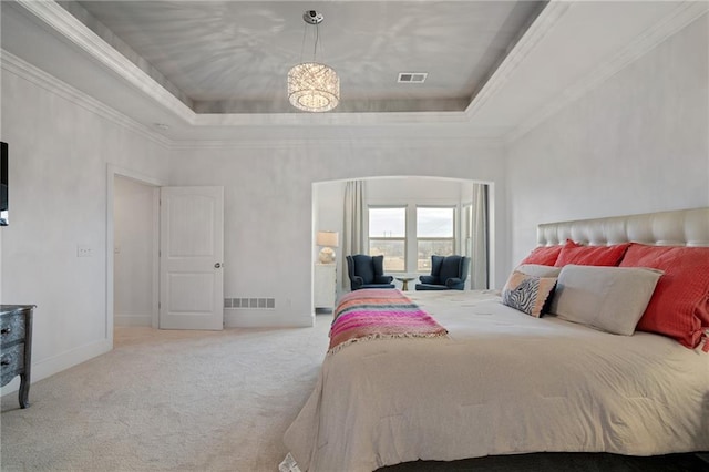 bedroom with carpet, visible vents, a raised ceiling, and ornamental molding