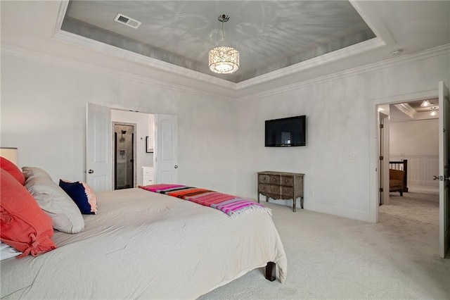 bedroom with carpet floors, a raised ceiling, visible vents, and crown molding