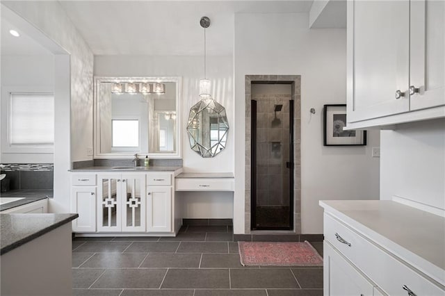 full bath featuring a stall shower, tile patterned flooring, and vanity