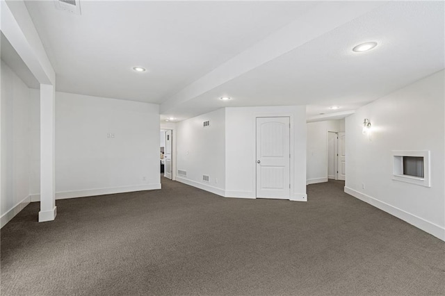 basement with visible vents, baseboards, dark colored carpet, and recessed lighting