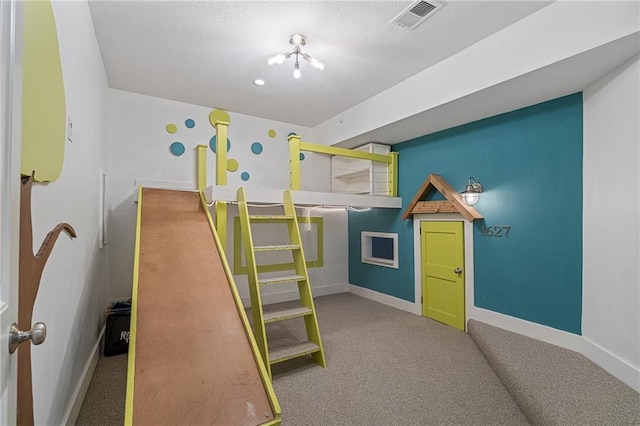 bedroom with baseboards, visible vents, a textured ceiling, and carpet flooring