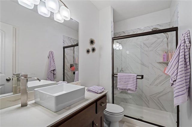 full bath featuring toilet, a shower stall, and vanity