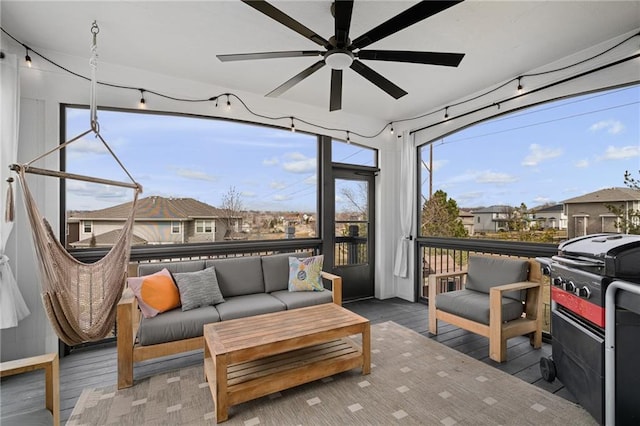 sunroom featuring ceiling fan