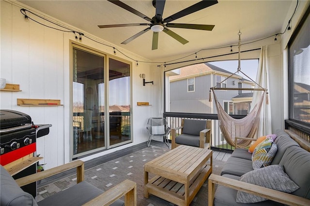 sunroom / solarium with a ceiling fan