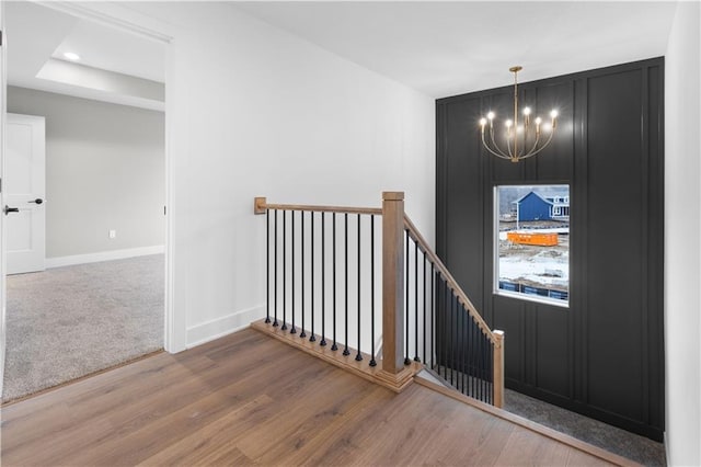 foyer featuring baseboards, a chandelier, wood finished floors, and recessed lighting