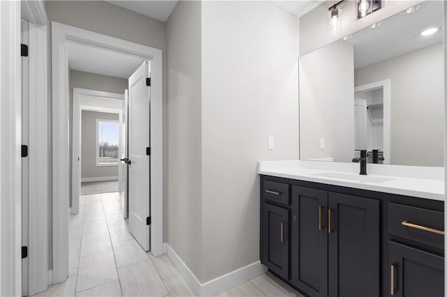 bathroom with vanity and baseboards