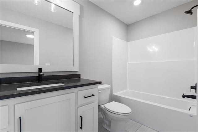 full bathroom with shower / bathing tub combination, vanity, and toilet