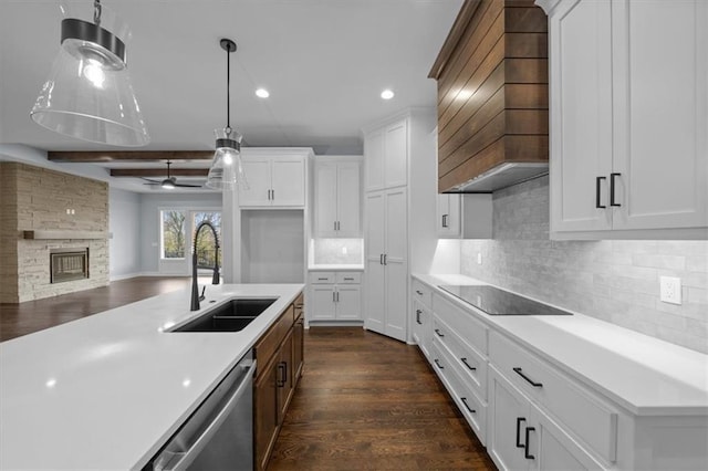 kitchen with white cabinets, dishwasher, custom exhaust hood, light countertops, and a sink