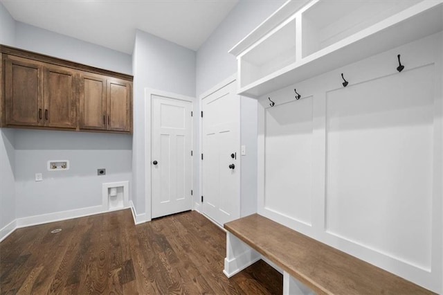 mudroom with dark wood finished floors and baseboards