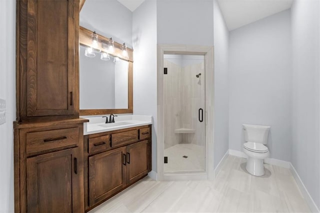 full bathroom with toilet, a shower stall, vanity, and baseboards