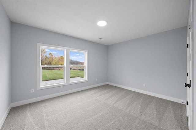 unfurnished room featuring carpet floors and baseboards