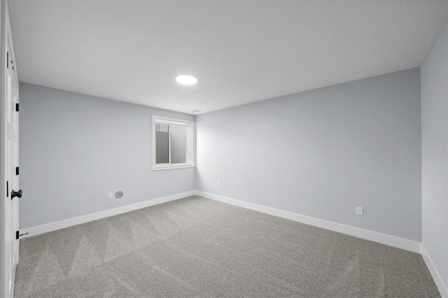 carpeted empty room with baseboards