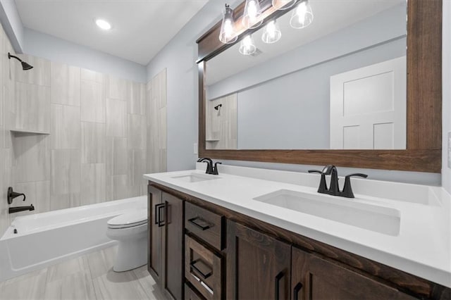 bathroom with shower / washtub combination, a sink, toilet, and double vanity