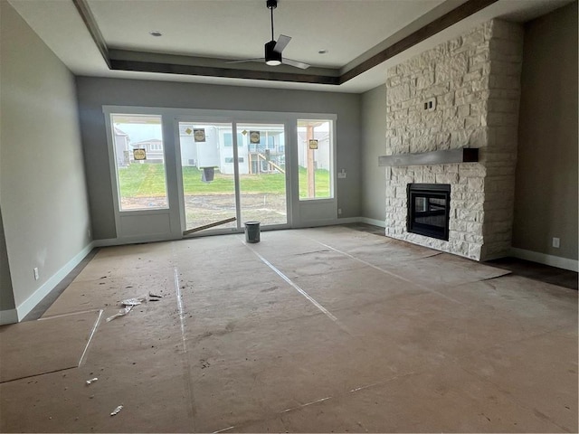 1708 SW Arbormist Dr, Lees Summit, MO 64082 - unfurnished living room with ceiling fan, a tray ceiling, and plenty of natural light