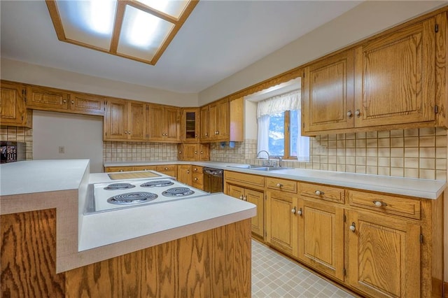 kitchen featuring white stovetop, black dishwasher, sink, and tasteful backsplash