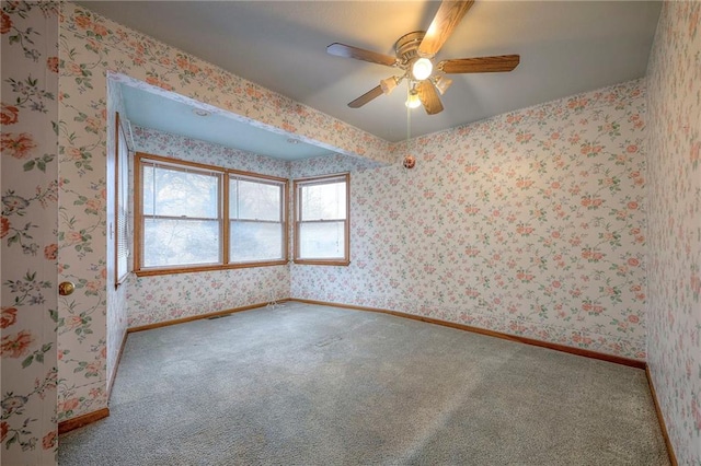 spare room with carpet and ceiling fan