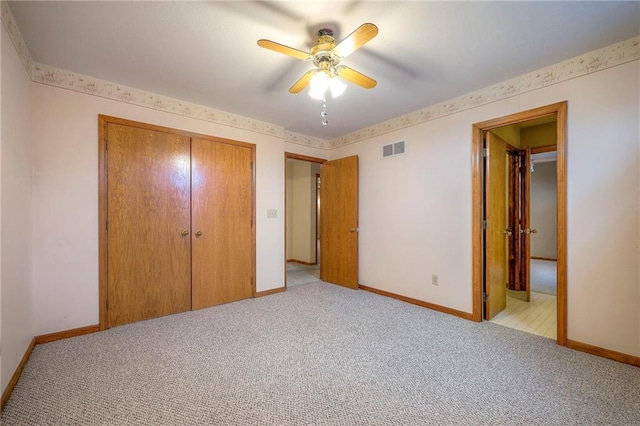 unfurnished bedroom with light carpet and ceiling fan