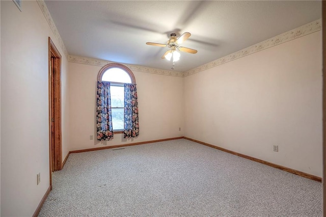 unfurnished room with light colored carpet and ceiling fan