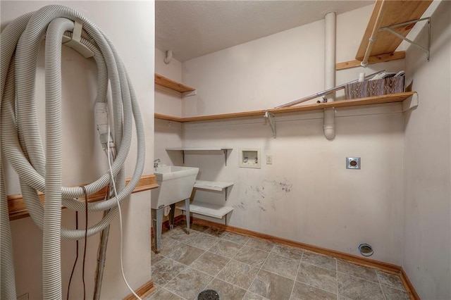 clothes washing area with sink, hookup for a washing machine, and electric dryer hookup