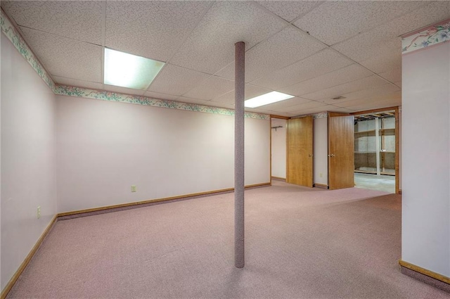 basement with carpet floors and a drop ceiling