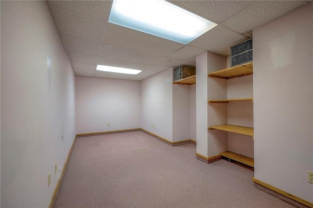 basement with a drop ceiling and carpet floors