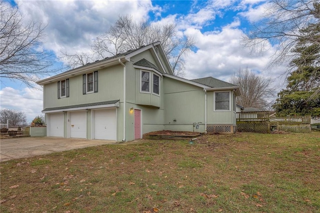 view of home's exterior featuring a wooden deck, a garage, and a lawn