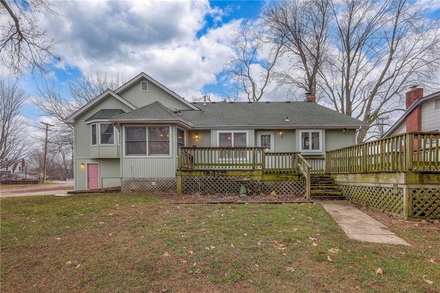 view of front facade with a deck and a front yard