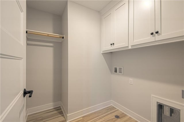 laundry area with cabinet space, hookup for a washing machine, baseboards, and light wood-style floors