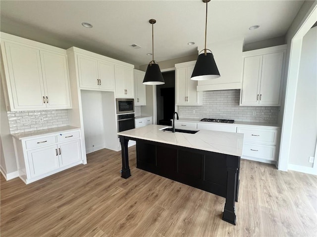 1712 SW Arbormist Dr, Lees Summit, MO 64082 - kitchen featuring backsplash, white cabinets, stainless steel microwave, light wood-style floors, and recessed lighting