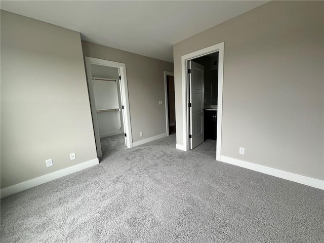 1712 SW Arbormist Dr, Lees Summit, MO 64082 - unfurnished bedroom featuring carpet, a spacious closet, a closet, and connected bathroom
