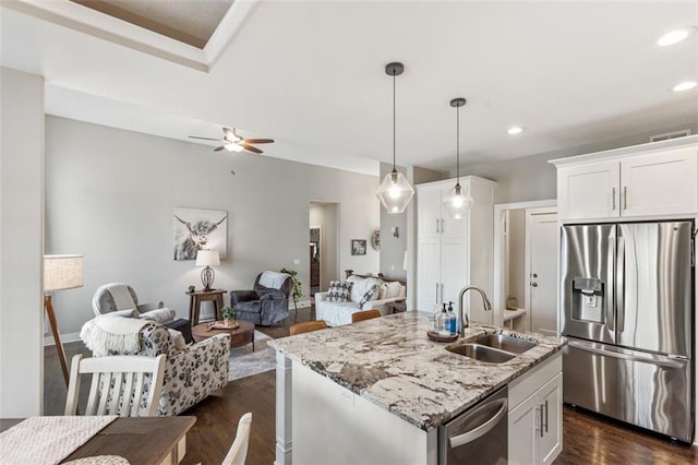 kitchen with sink, white cabinetry, pendant lighting, and appliances with stainless steel finishes