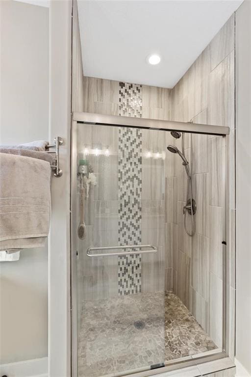 bathroom with a shower with door