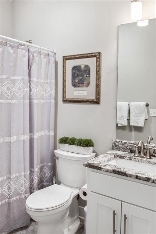 bathroom with toilet and vanity