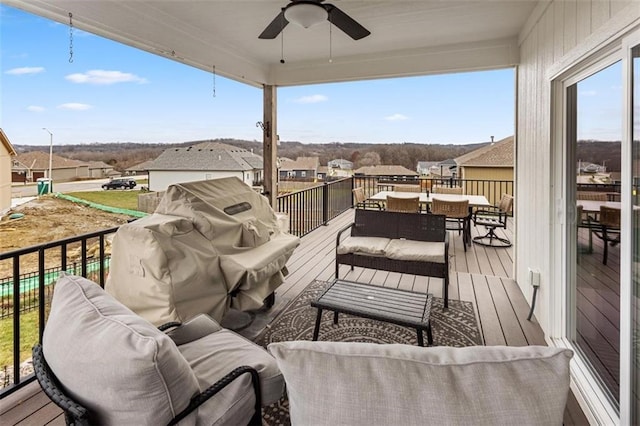 deck featuring ceiling fan and outdoor lounge area