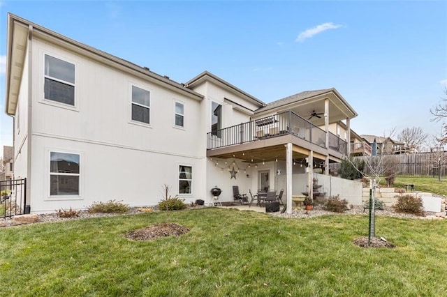 rear view of house with a deck, a yard, ceiling fan, and a patio