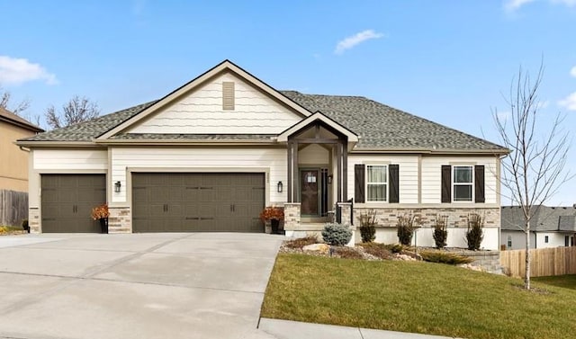 view of front of house with a garage and a front lawn