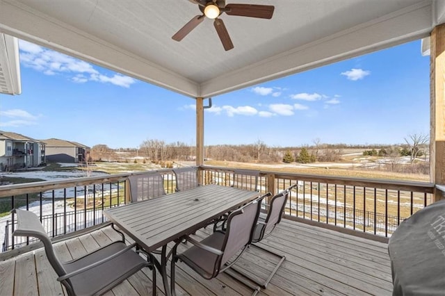 wooden deck featuring ceiling fan and a grill