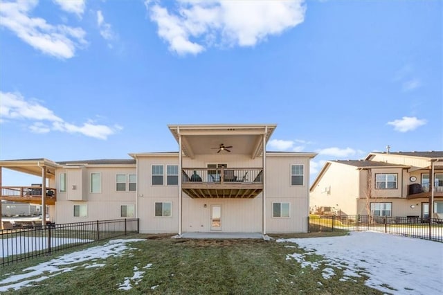 back of house with ceiling fan, a patio, a balcony, and a lawn