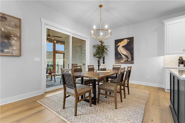 dining room featuring an inviting chandelier and light wood-type flooring