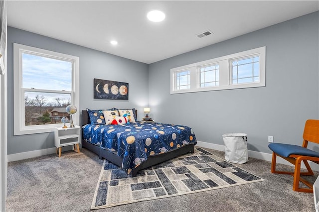 bedroom with carpet flooring and multiple windows